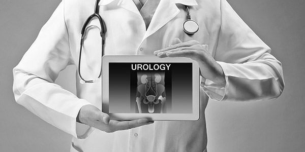 Doctor with stethoscope on his neck holding a tablet with Urology on it