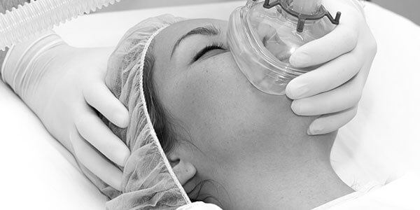 Doctor putting oxygen mask to a patient