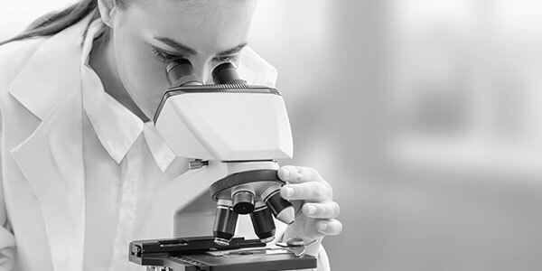 woman doctor looking into a microscope